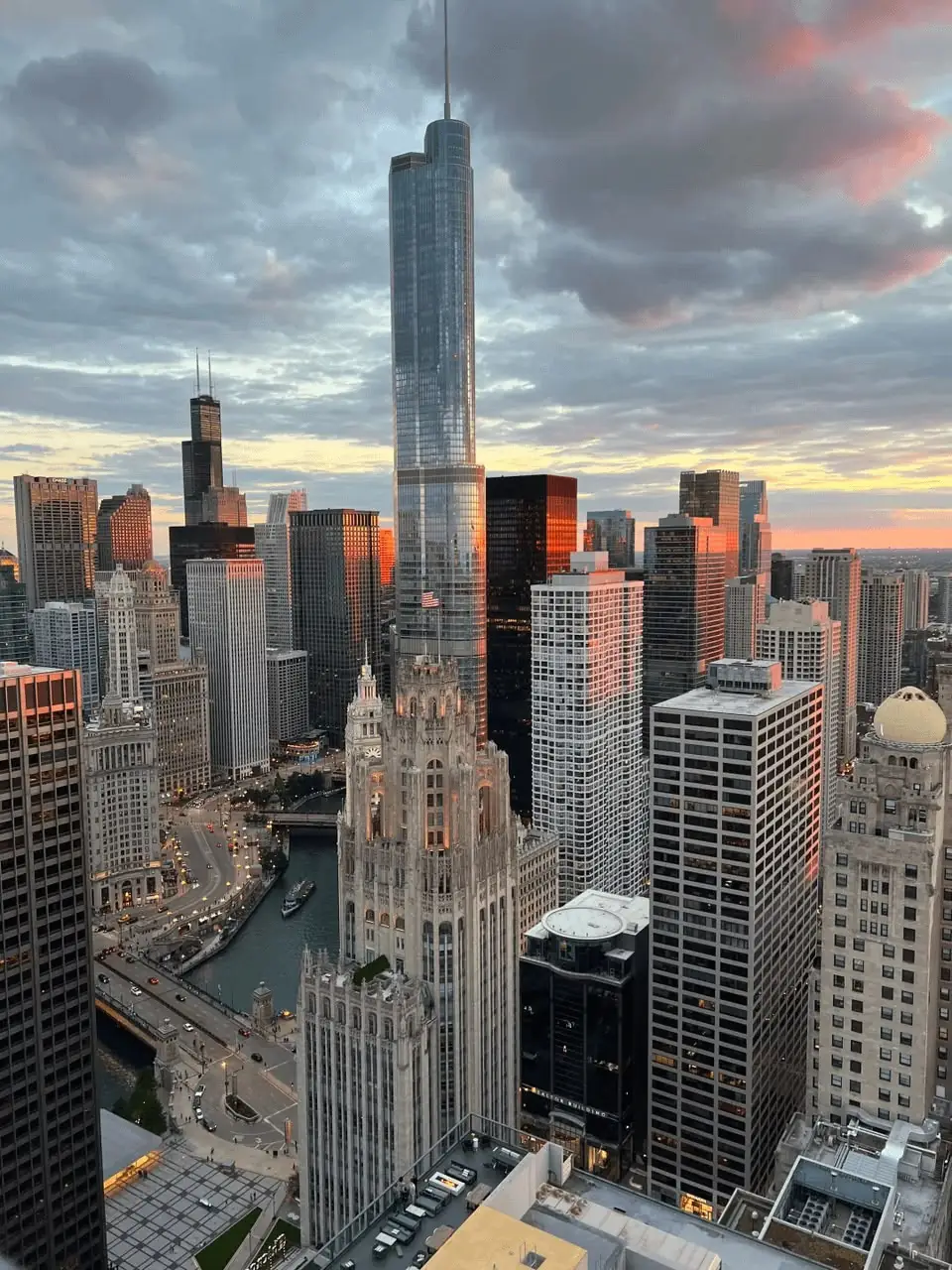 An aerial view of downtown Chicago and the Chicago River under evening clouds