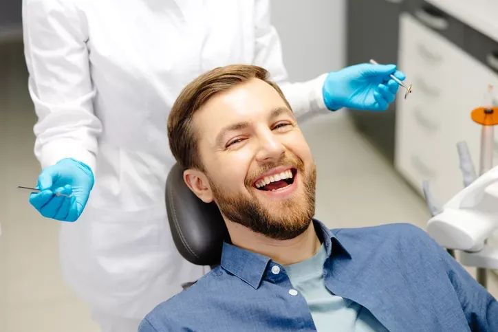 Smiling patient in a dental chair during a checkup